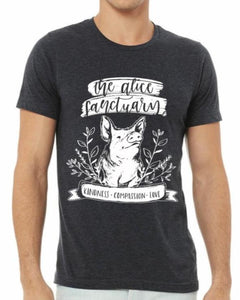 Man wearing a dark grey t-shirt with the words "The Alice Sanctuary - kindness, compassion, love" printed above a drawing of a pig.